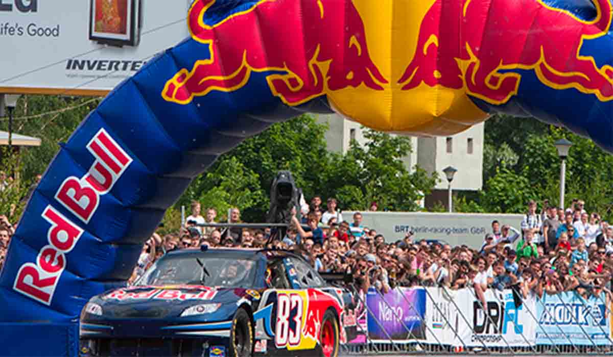 a archway entrance with an energy drink advertisement