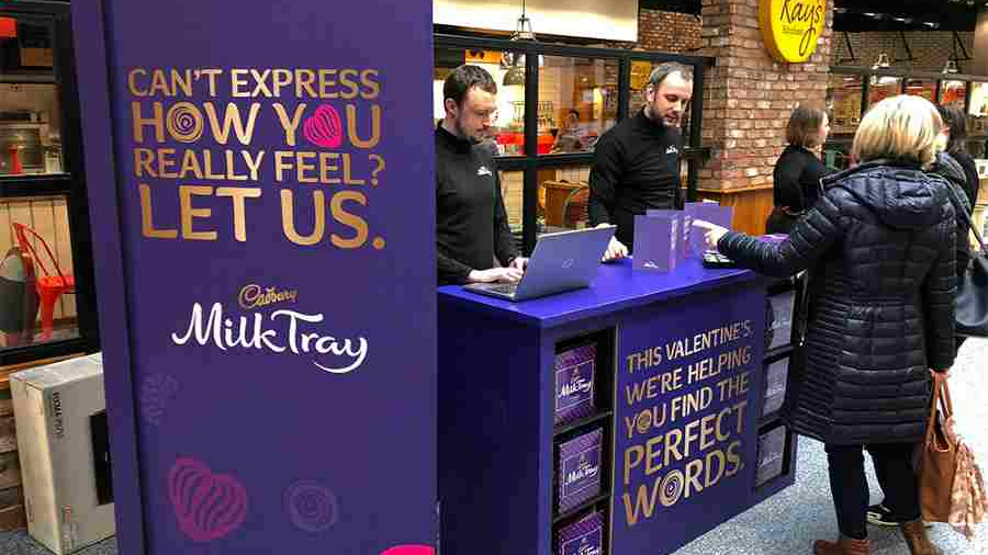 Cadbury Milk Tray Valentine’s activation booth helping shoppers create personalized messages in a mall.