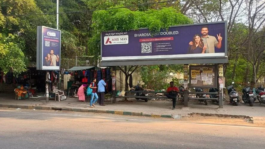 Bus stop advertising campaign by Axis Max Life Insurance in India Axis Max Life Insurance bus shelter advertisement with QR code and local audience engagement