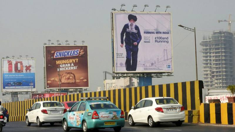 Urban Billboard Cluster Outdoor Advertising Multiple billboards placed in urban street showcasing diverse outdoor advertising campaigns