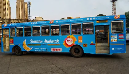 City bus wrapped with Ramzan Mubarak themed advertising featuring Switz food brand messaging in transit media format
