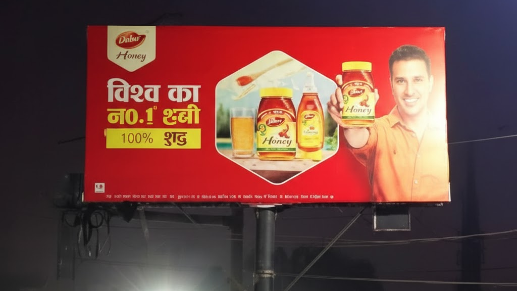 Dabur Honey outdoor billboard advertising with large format hoarding promoting pure honey product
