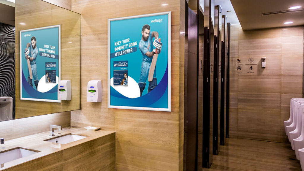 restroom advertising poster inside mall washroom targeting captive audience attention