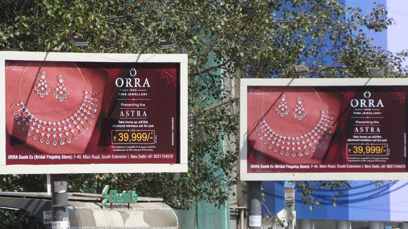 Dual roadside billboards promoting ORRA fine jewellery Astra collection with diamond necklace visuals and pricing offer
