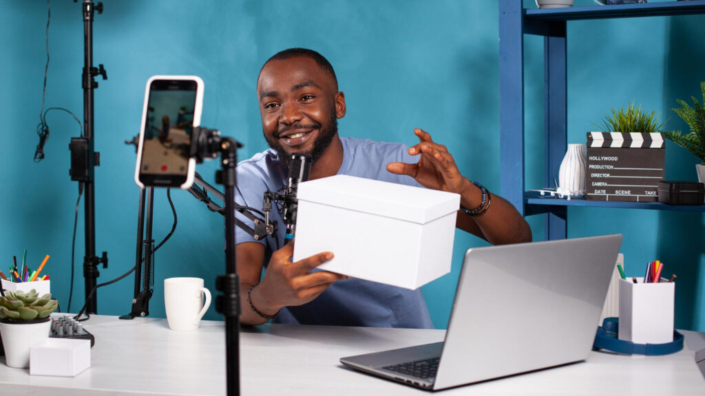 Content creator recording product video with smartphone and microphone for influencer marketing campaign