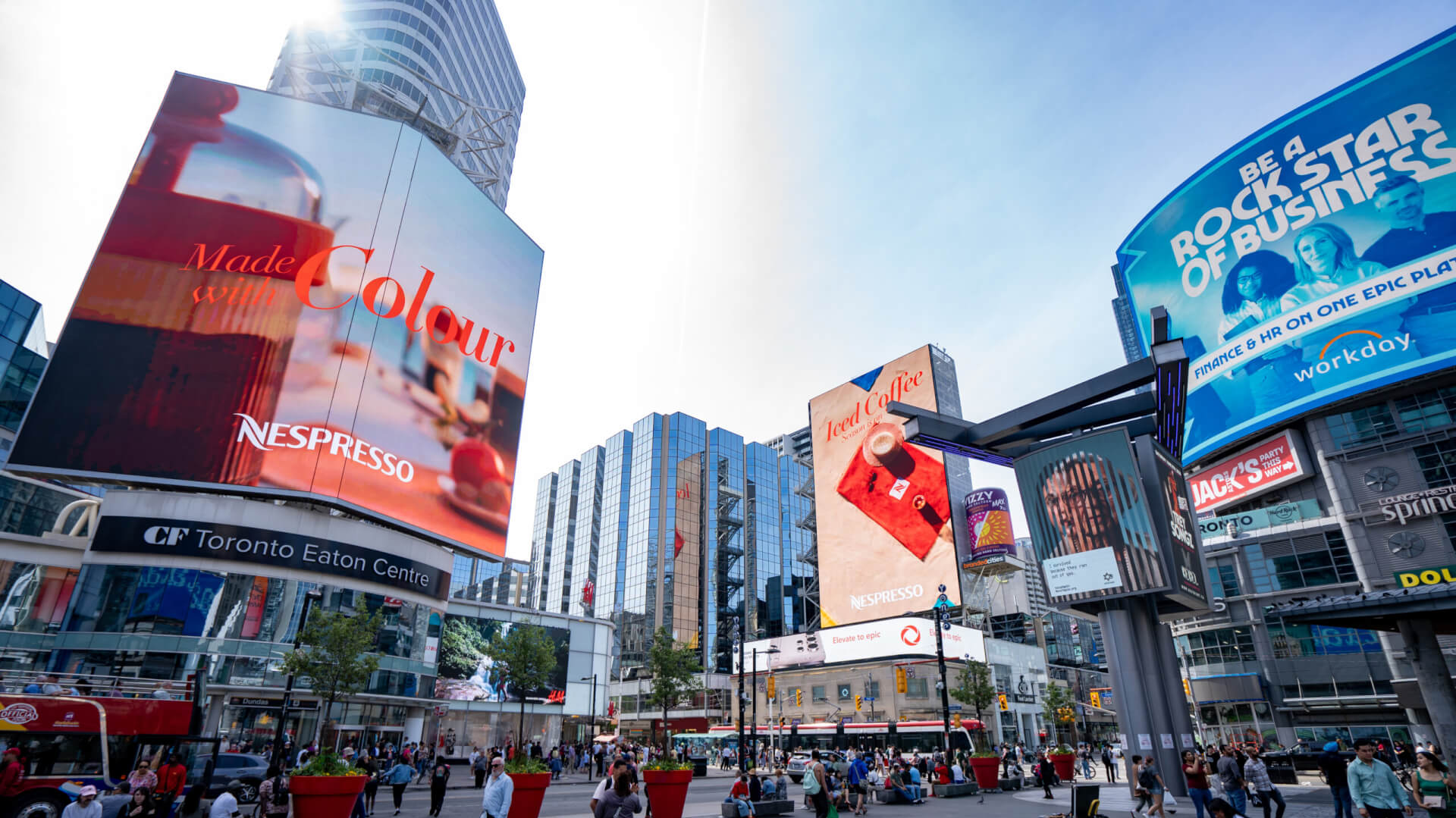 High impact digital billboards in Times Square showcasing multiple brand advertisements and immersive DOOH environment